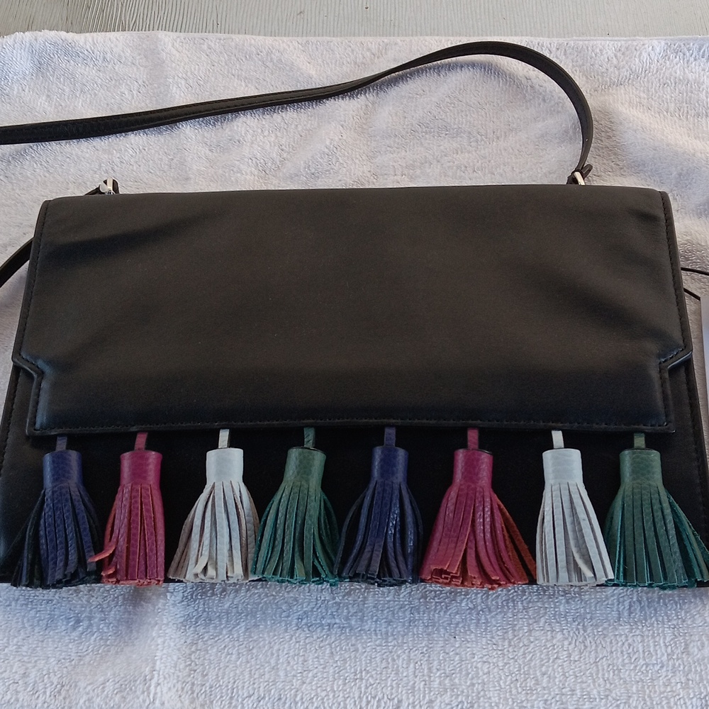 Rebecca Minkoff black leather envelope style crossbody bag with tassles.